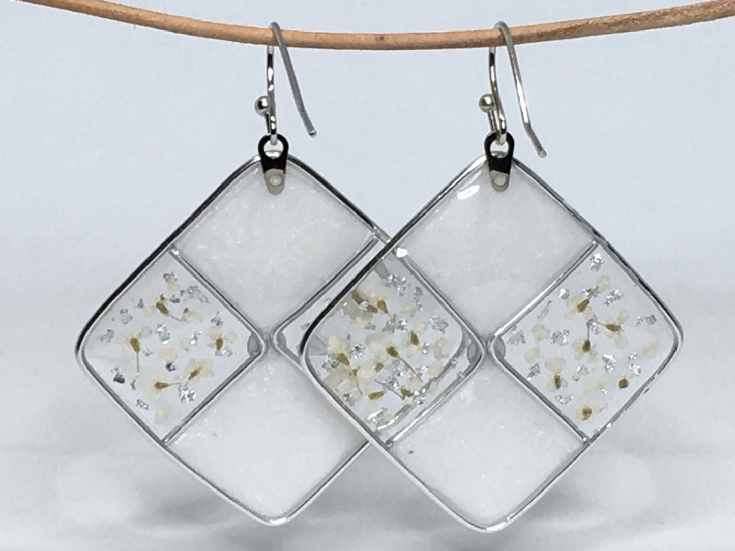 White resin earrings with white pressed flowers