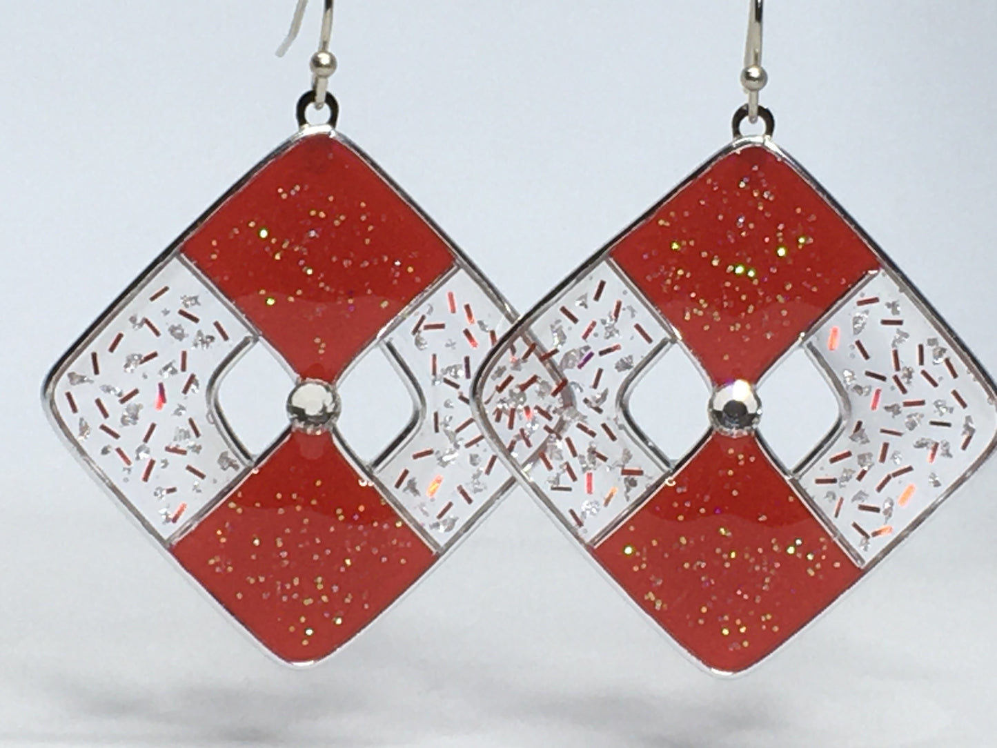 Red glittered and silver earrings