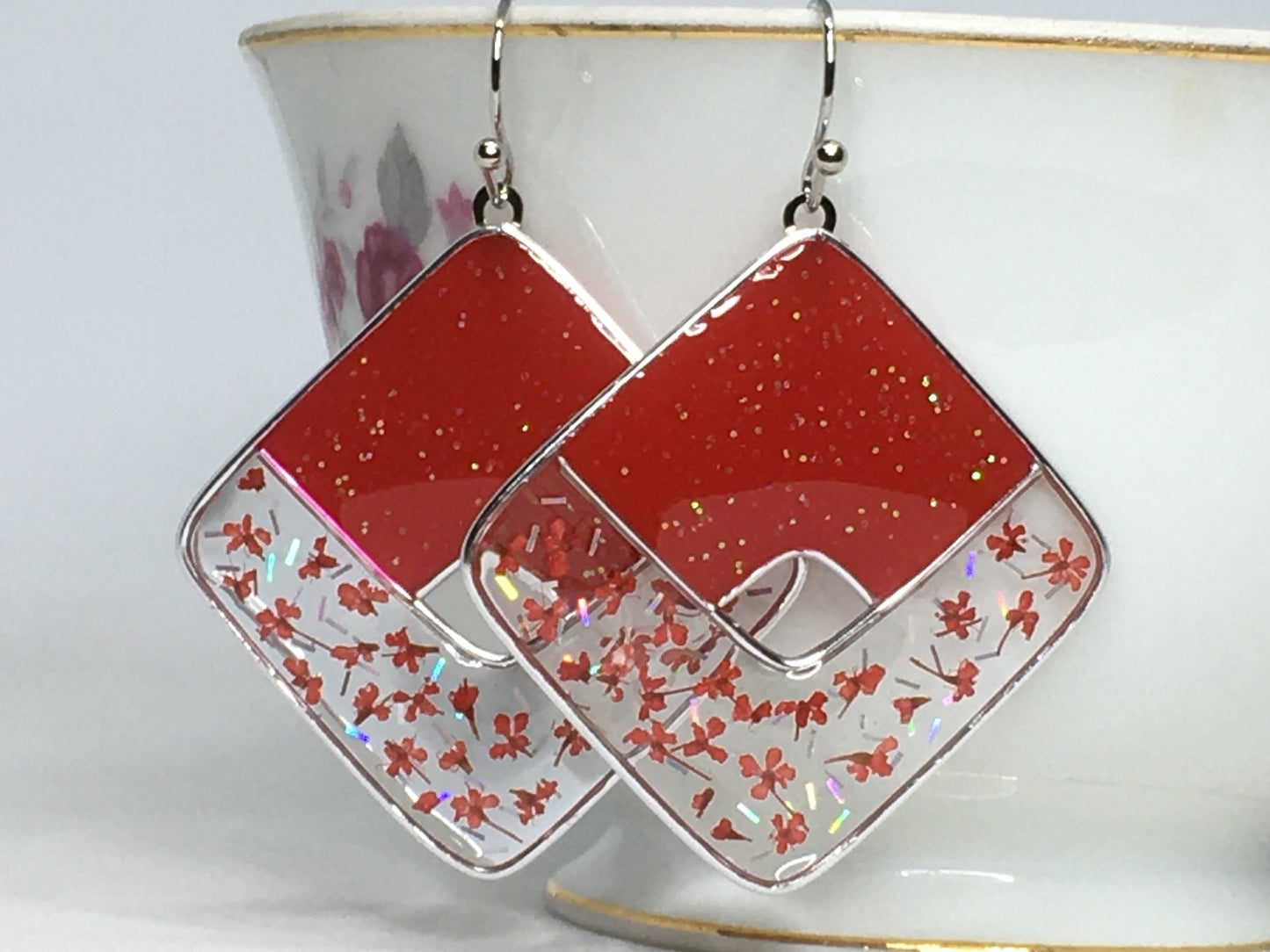 Red glittered earrings with red pressed flowers