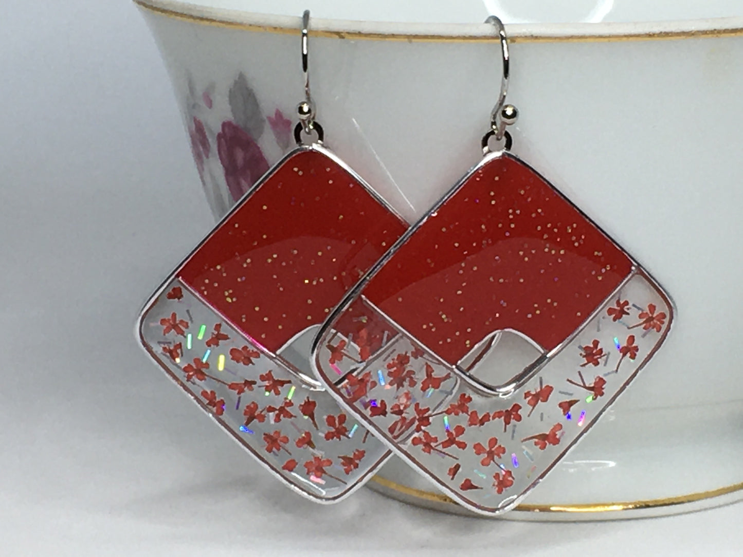 Red glittered earrings with red pressed flowers