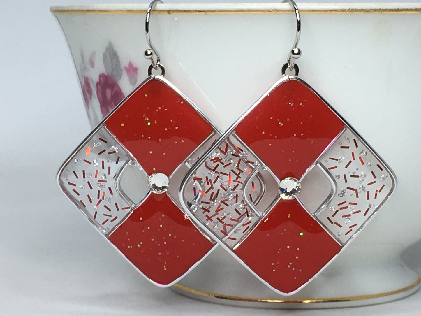 Red glittered and silver earrings